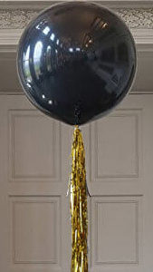 black jumbo balloon with gold tassel